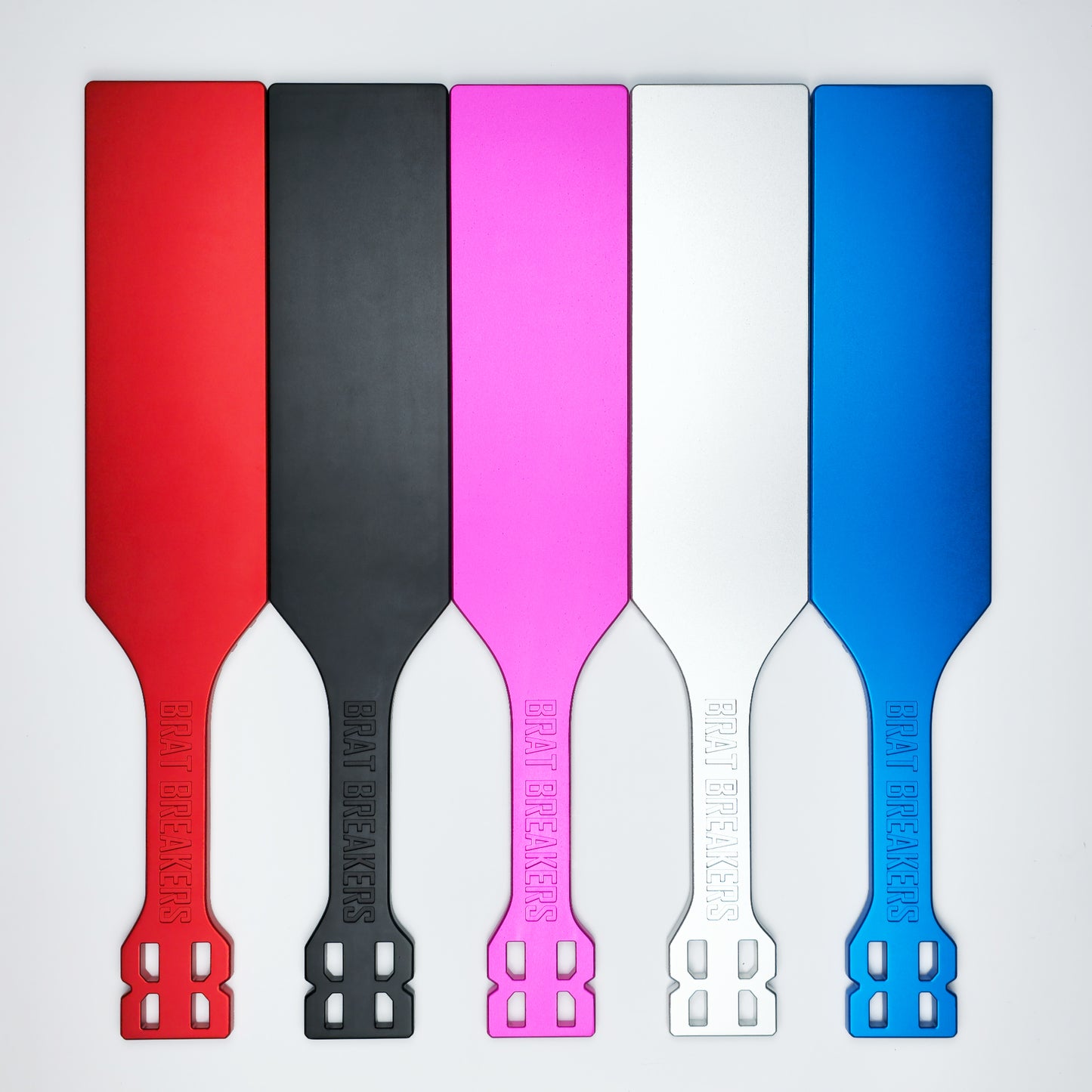 Collection of Spanking Paddles made by Brat Breakers in five different colours