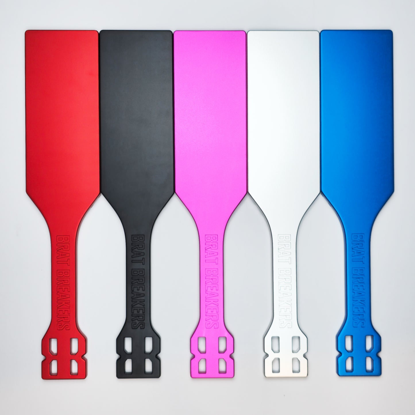 Collection of Spanking Paddles made by Brat Breakers in five different colours