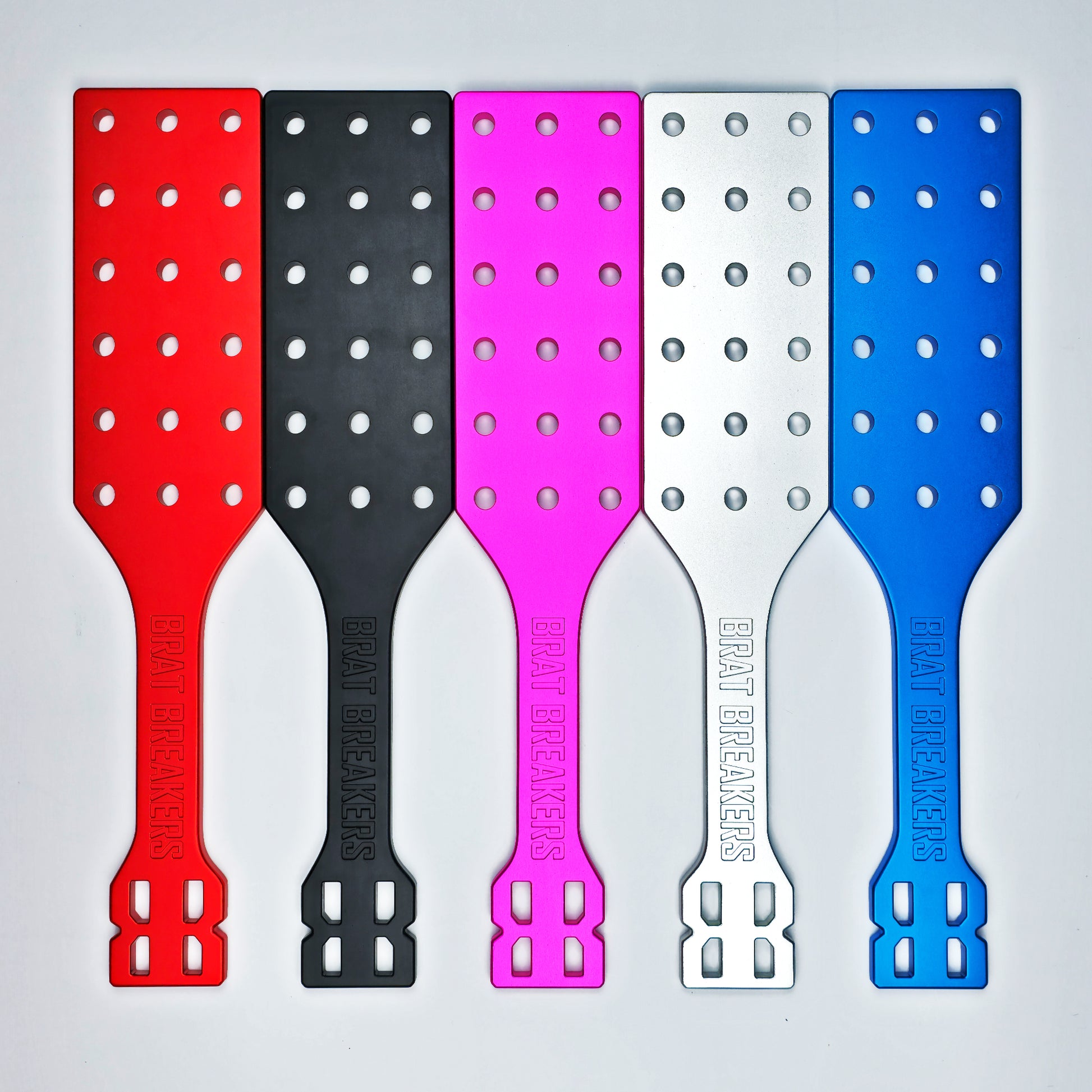 Collection of Spanking Paddles made by Brat Breakers in five different colours