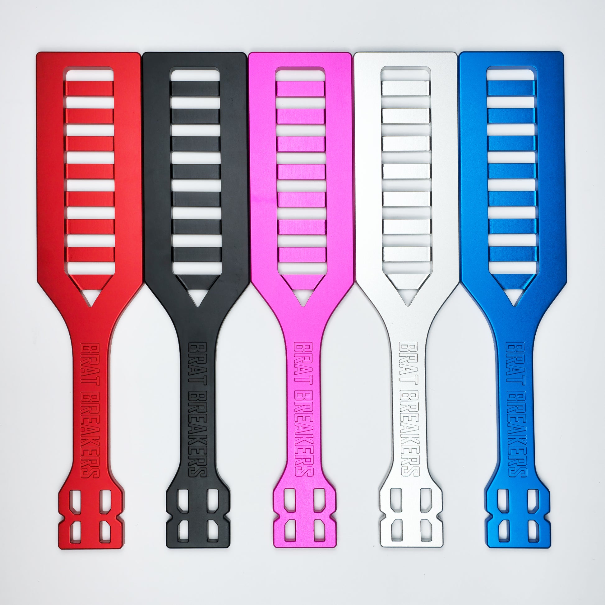 Collection of Spanking Paddles made by Brat Breakers in five different colours