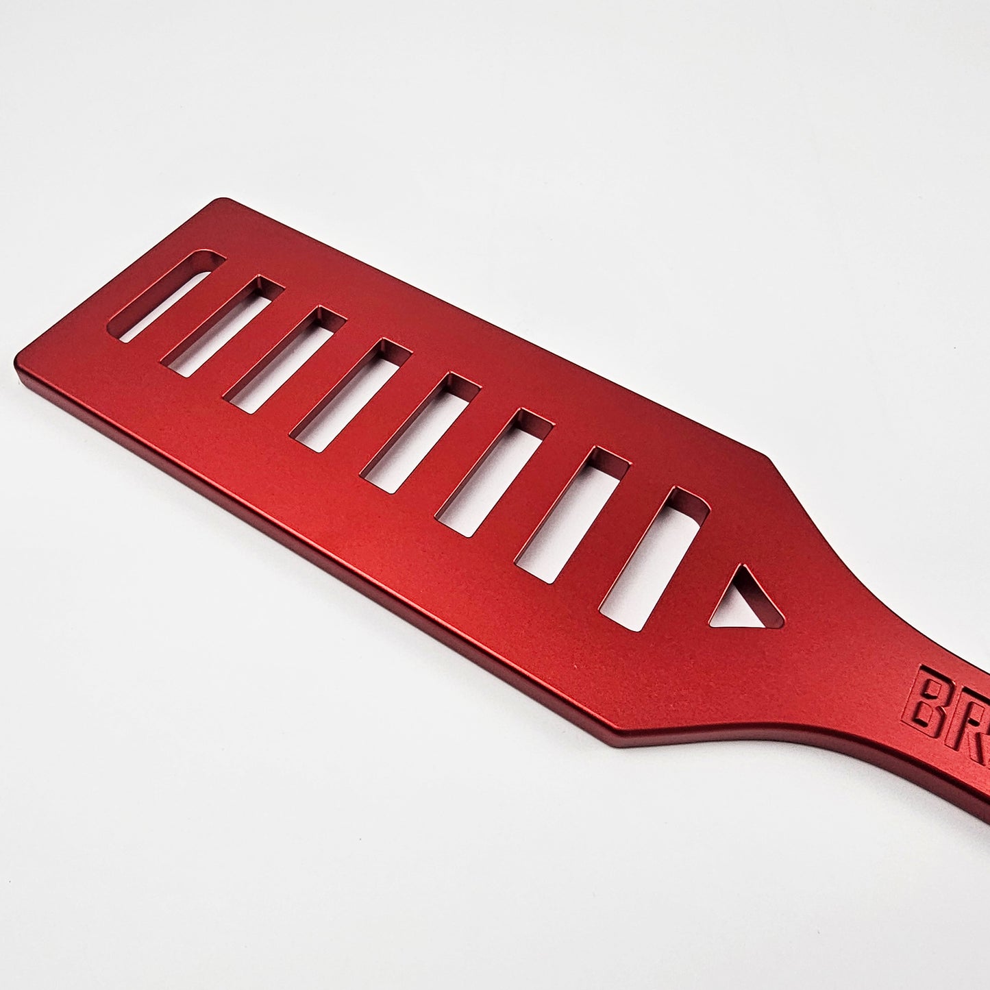 Red Steel Spanking Paddle with holes made by Brat Breakers