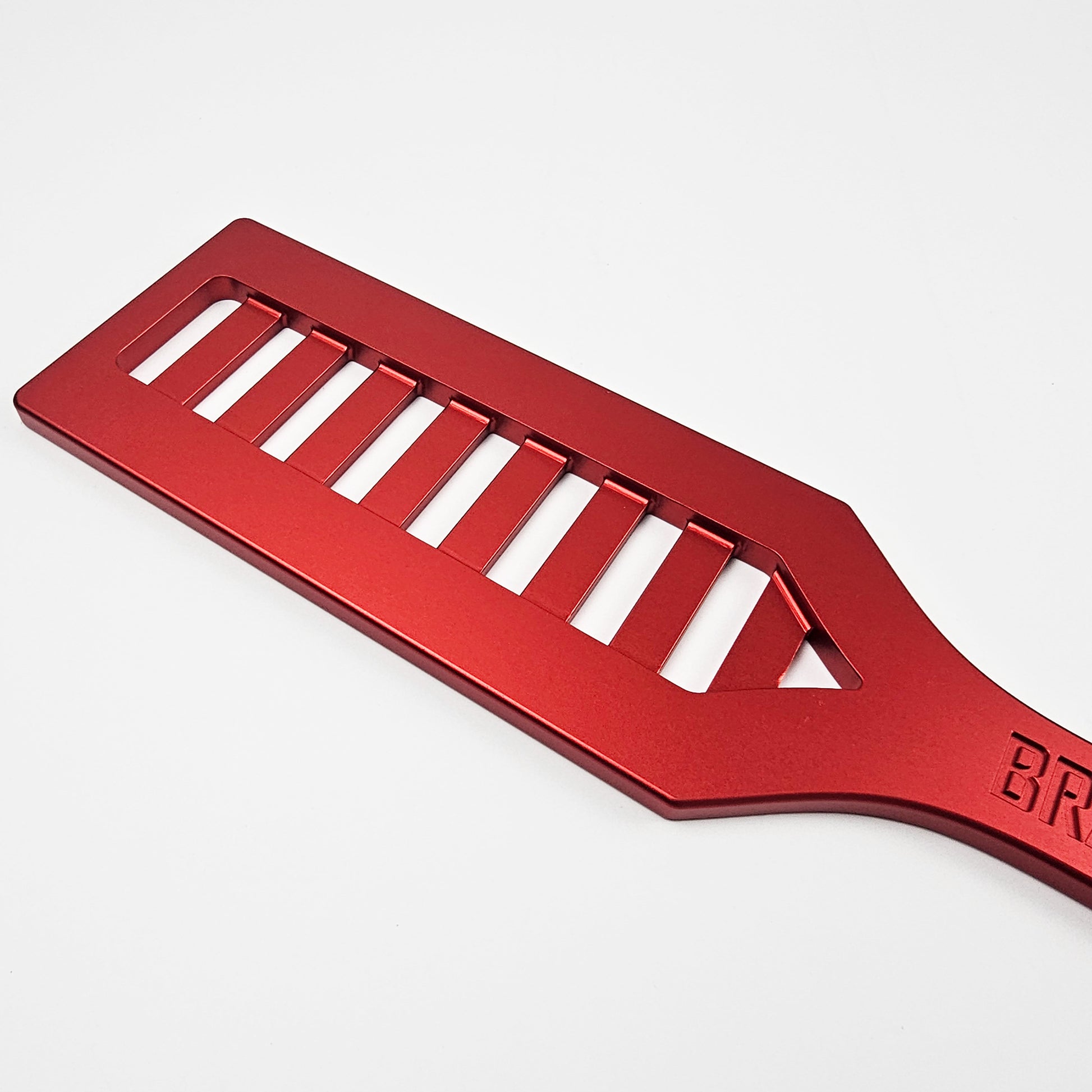 Red Steel Spanking Paddle with holes made by Brat Breakers