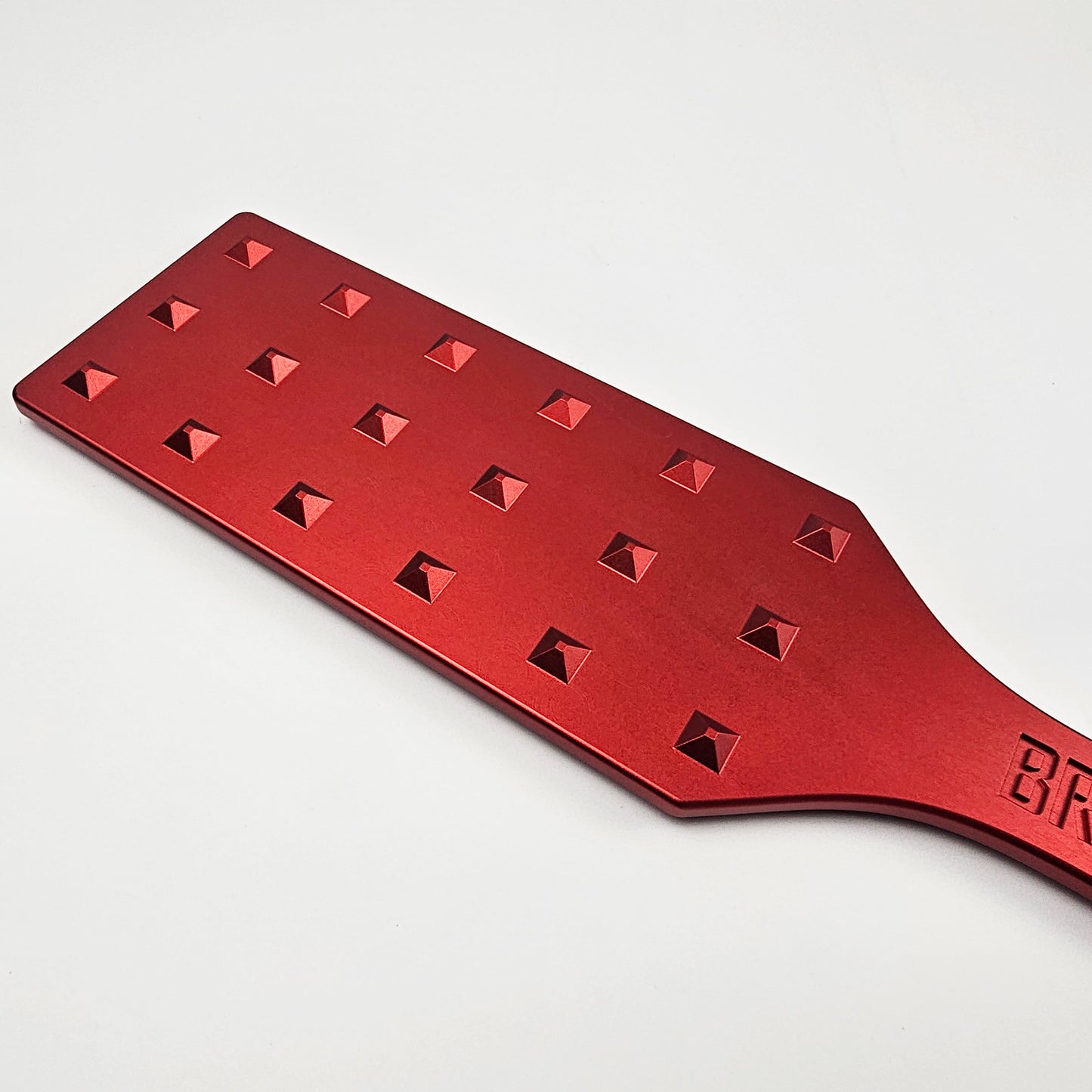 Red Steel Spanking Paddle with studs made by Brat Breakers