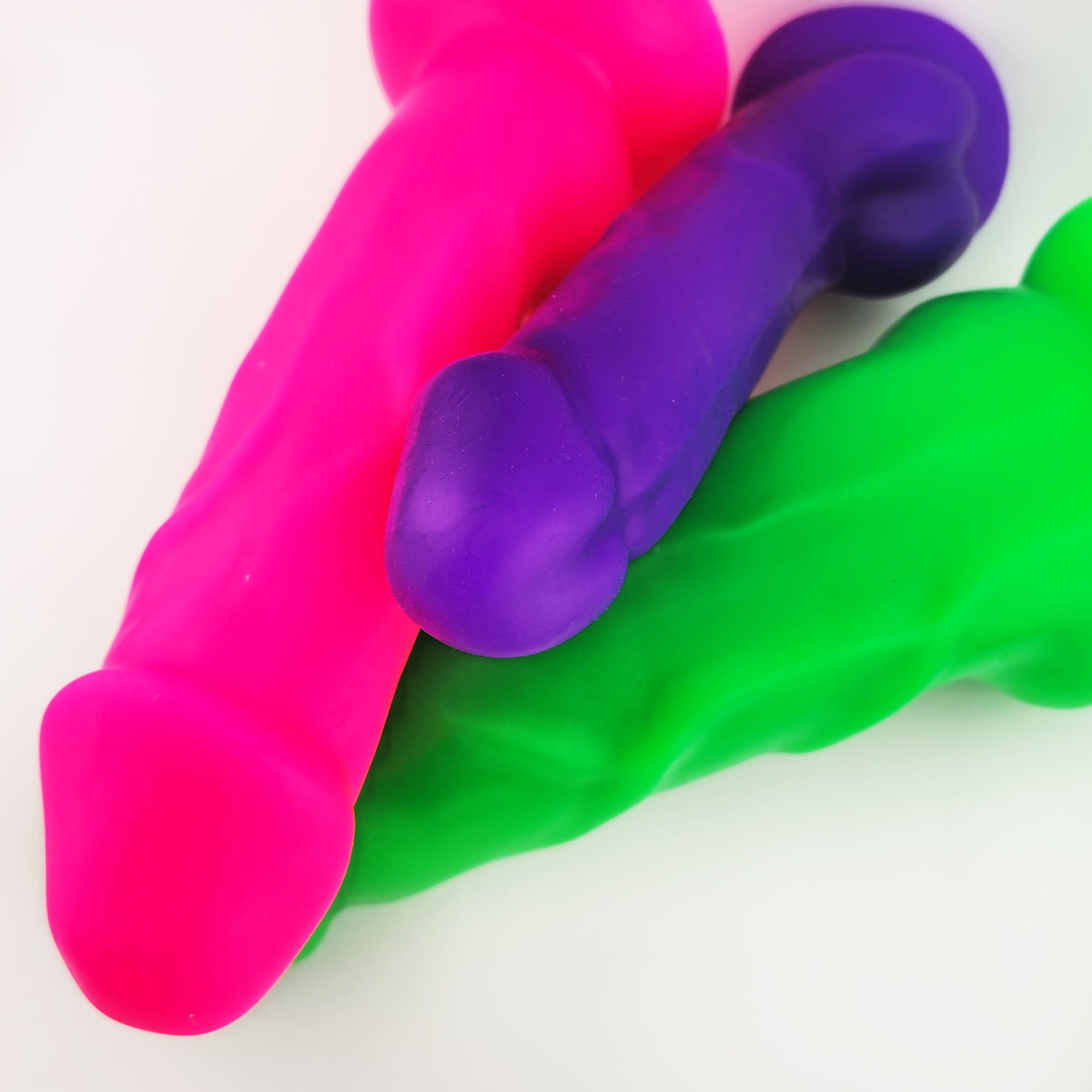 Brat Breakers Daaaddy Silicone dildo in three sizes. Pink, Purple and green dildos